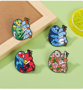 Detailed close-up of four colorful enamel sloth pins with landscape and floral designs