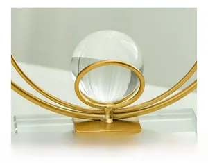 Macro shot of a luxury crystal ball with golden metal stand and a solid glass base
