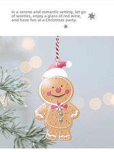 Detail of gingerbread man Christmas ornament with red hat and festive hanging rope
