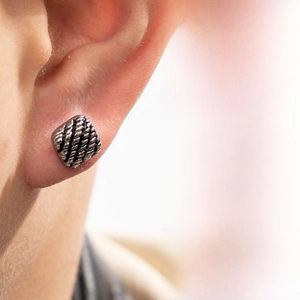 Close-up of square stud earring with vintage twisted rope texture on male model