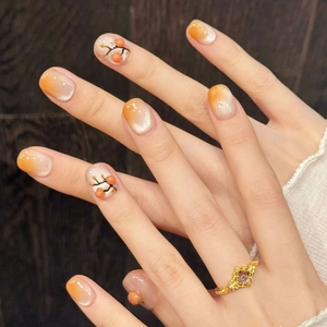 Cat eye press-on nails with 3D persimmon design and orange gradient finish