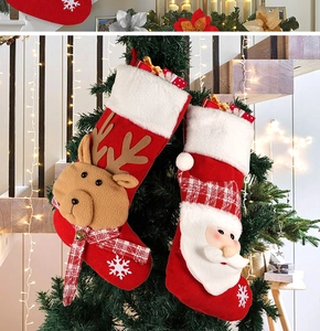 Detail of Christmas stocking gift bag with 3D Santa and reindeer on festive fireplace