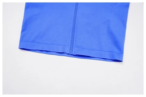 Detailed macro view of the blue yoga jacket featuring a ribbed hem and seamless knit texture