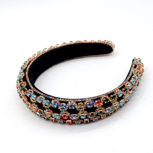Close-up of multicolor rhinestones and velvet lining on a royal style sponge headband