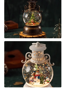Close-up of vintage bronze and white Christmas snow globe lanterns with warm LED lighting