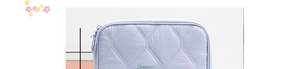 Detailed close-up of light purple quilted tablet sleeve with diamond stitching and zipper
