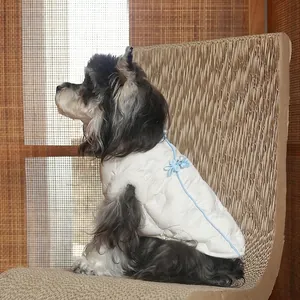 Quilted white pet vest with blue trim and traditional Chinese knot buttons for dogs
