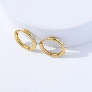 Detailed view of gold stainless steel hoop earrings with sparkling crystal inlay