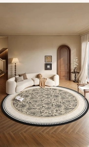 French retro round rug with black and white rose floral pattern on herringbone wood floor