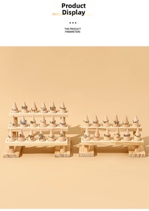 Close-up of gold and silver rings displayed on conical solid wood tiered jewelry stands