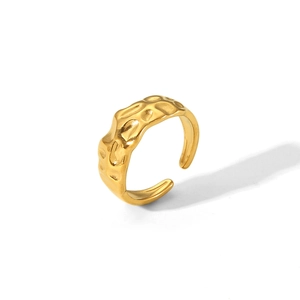 Detailed view of the irregular hammered texture and golden finish on the stainless steel ring