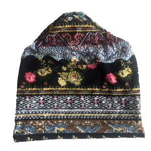 Detailed view of paisley and bohemian floral print patterns on the knit beanie hat