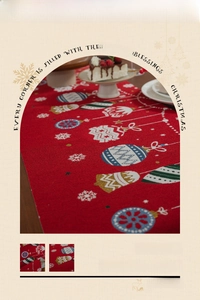 Detail view of red Christmas table runner with festive jacquard patterns and holiday motifs