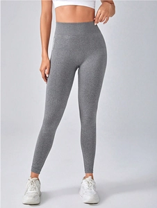 Detail shot of seamless high waist grey yoga pants with white gymwear text print