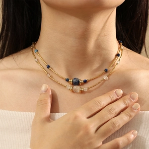 Detail of bohemian double-layered beaded necklace with blue lapis and gold accents
