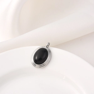 Tiger stone oval pendant with 18K silver plated frame on white fabric background