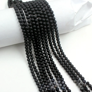 Macro detail of matte black stone round beads for DIY handmade jewelry crafting