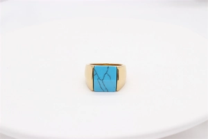 Detail of vintage gold square ring with blue turquoise stone inlay for men