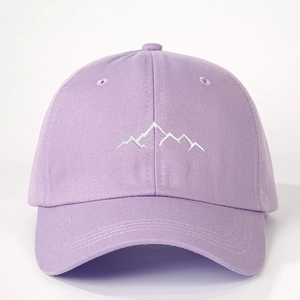 Close-up of white mountain embroidery on high-quality light purple canvas baseball cap