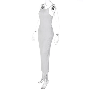 Detail shot of the fine pleated texture and vertical ribbed fabric on a white maxi dress