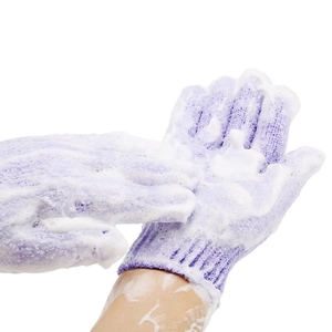 Purple exfoliating bath gloves generating rich white foam for deep skin cleansing