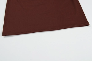 Detailed close-up of double-stitched hem on dark brown bodycon dress with premium fabric