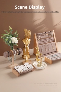 Detailed close-up of velvet jewelry display stands with wooden bases and golden mannequin