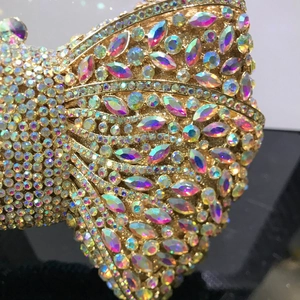 Detailed macro view of vibrant colorful rhinestones on a golden metal evening clutch bag