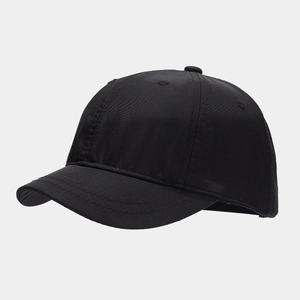 Close-up of black short brim baseball cap showing 6-panel structure and stitch detail
