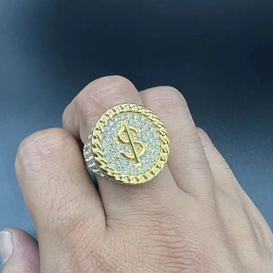 Close-up of gold plated ring featuring a 3D dollar sign symbol and pavé cubic zirconia