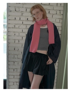 Pink knit wool scarf styled with a dark navy trench coat and casual autumn outfit