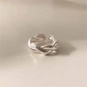 Elegant 925 sterling silver minimalist double twist open ring on a beige background