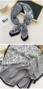 Detail of silk scarf with houndstooth and paisley print in black and white finish