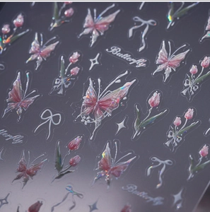 Macro detail of laser aurora butterfly and tulip nail stickers with watercolor effect