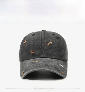 Detailed close-up of dark grey washed cotton baseball cap with puppy embroidery