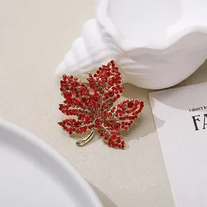 Elegant maple leaf brooch with red crystals and gold-plated base for women's clothing