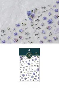 Detail of blue and purple watercolor hydrangea nail stickers with cursive text accents