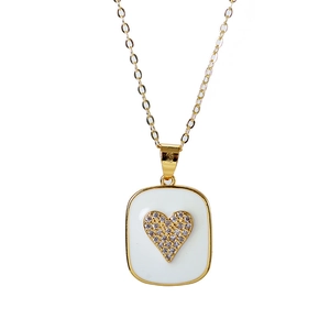 Detailed macro view of heart pendant featuring white enamel and sparkling zircon stones