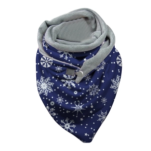 Detail of navy blue Christmas infinity scarf with white snowflake patterns and button