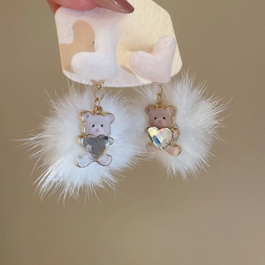 Detail showing S925 silver needle, white plush ball, and cute bear pendant earring
