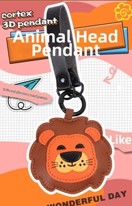 Detail of a handmade lion leather keychain with fine stitching and black metal hook