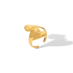 Detailed close-up of golden irregular curved open ring with heart-shaped abstract design