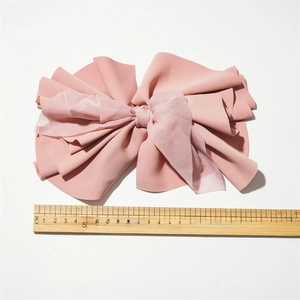 Pink fabric bow hair clip with double layer tulle, 21cm size shown on wooden ruler