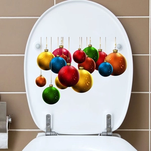 Detail of colorful Christmas ball wall stickers applied on a white toilet seat cover