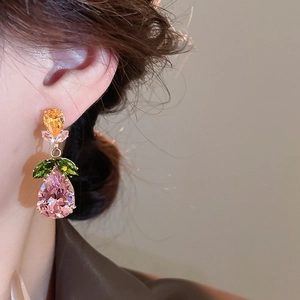 Close-up of luxury leaf earrings with yellow, green and pink pear-shaped cubic zirconia