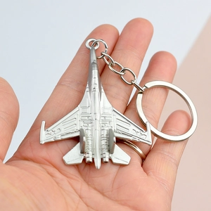 Silver metal fighter jet keychain model souvenir with detailed metallic texture finish