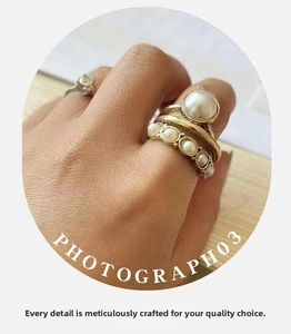 Detail of vintage gold pearl rings set featuring a large open ring and pearl band