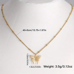 Elegant gold butterfly pendant necklace with zircon crystals on a white mannequin stand