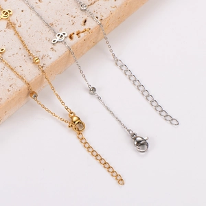Gold and silver stainless steel musical note anklets with zircon on beige stone