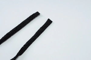 Macro shot of black floral lace fabric on a halter backless jumpsuit with fine details